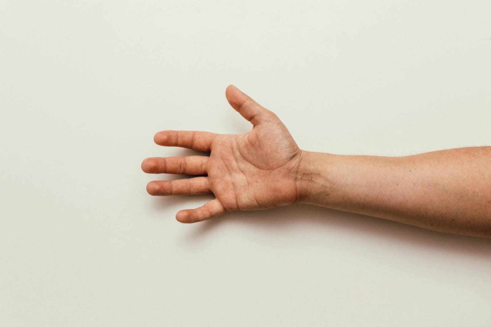Open hand receiving digital marketing strategy insights for Australian small businesses against white background